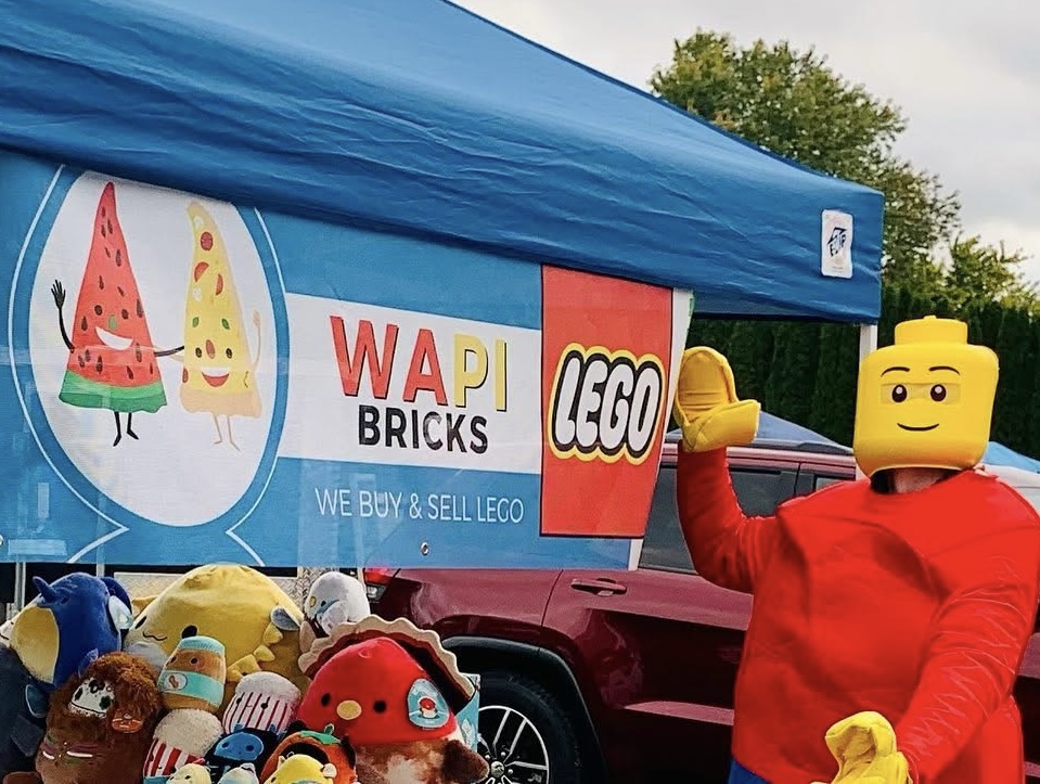 The original Wapi Bricks watermelon and pizza logo displayed at an outdoor event